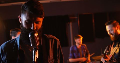 Indie band performing energetically in recording studio