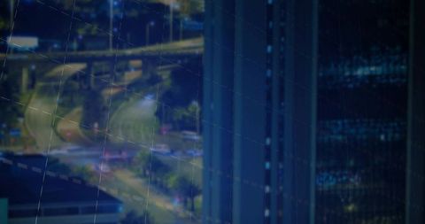 Reflective building facade overlooking urban transportation landscape