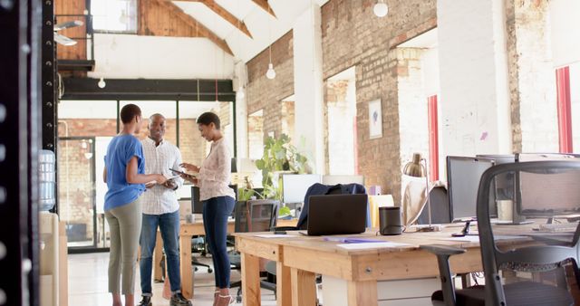 Colleagues Collaborating in Modern Loft Office with Brick Wall and High Ceilings - Download Free Stock Images Pikwizard.com