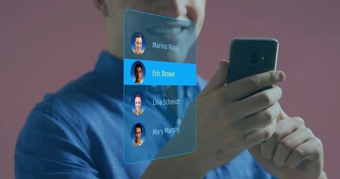 Smiling man selecting contact on holographic AR smartphone interface