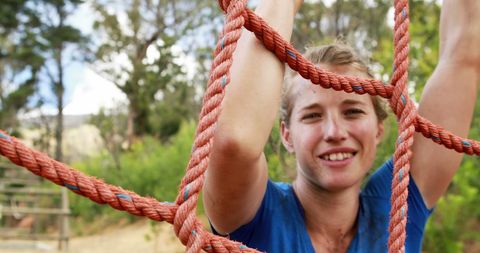 Woman Climbing Rope Net in Outdoor Adventure Course - Download Free Stock Images Pikwizard.com