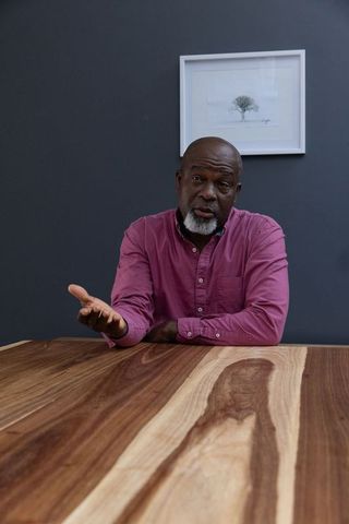 Senior professional admiring artwork in contemporary office