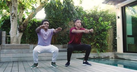Diverse Friends Exercising Together Outdoors by a Pool