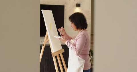 Senior Asian Woman Painting on Canvas at Home Art Studio