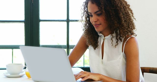 Smiling Woman Working on Laptop in Bright Indoor Space - Download Free Stock Images Pikwizard.com