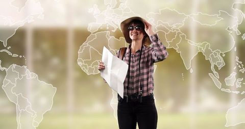 Young woman tourist explorers world with map and sun hat