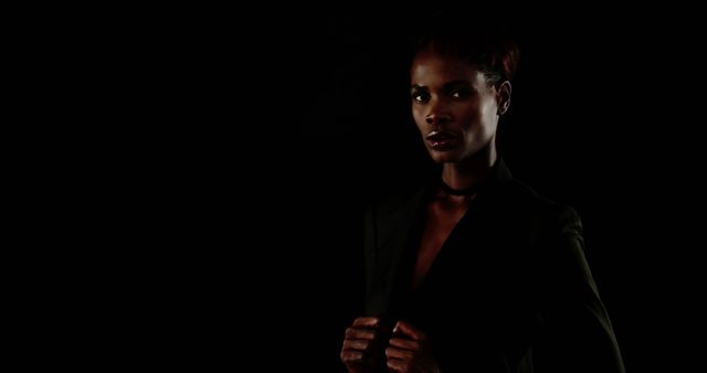 Confident Woman in Black Suit Against Dark Background - Download Free Stock Images Pikwizard.com