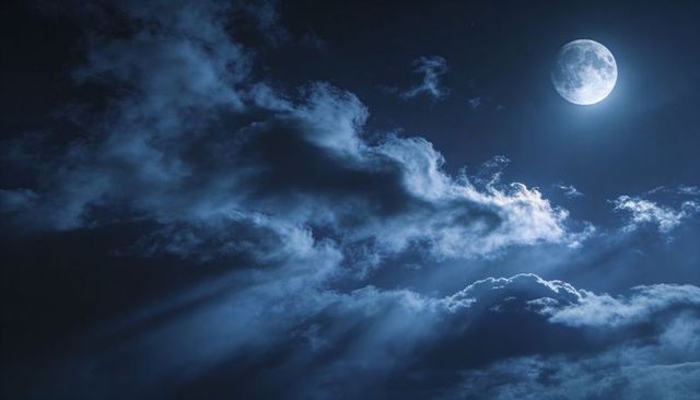 Full Moon Casting Silver Light Through Dramatic Midnight Clouds