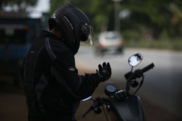 Motorcyclist Preparing for Ride on Rural Roadside - Download Free Stock Images Pikwizard.com