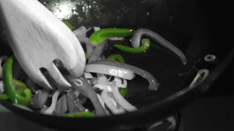 Mixing Sautéed Vegetables in Wok with Gently Stirring Motion