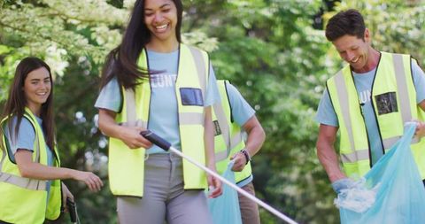 Eco volunteers collecting litter in wooded area
