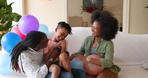 Happy Family Celebrating Son's Birthday at Home