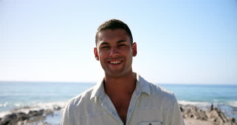 Smiling Young Man Enjoying Sunny Beach Day