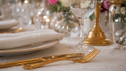 Elegant Gold Cutlery and Crystal Glass on Luxury Banquet Table with Candlelight