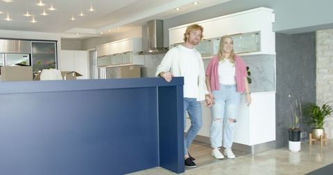 Couple Touring New Home Joyful Exploration Modern Kitchen