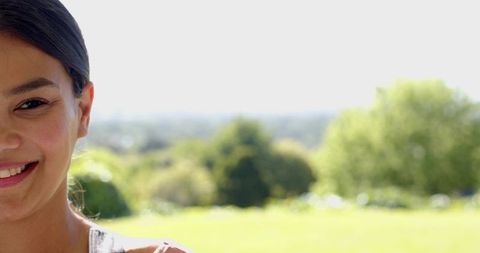 Smiling Person Relaxing on Sunny Day with Lush Greenery