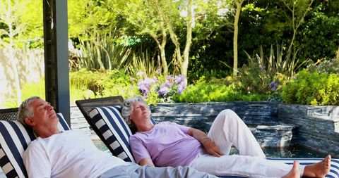 Senior Couple Relaxing Outdoors in Peaceful Garden