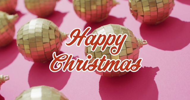 This image depicts a festive 'Happy Christmas' greeting over gold baubles on a pink background. It conveys celebration and holiday cheer. It can be used for holiday cards, social media posts or any Christmas-themed project to spread seasonal joy.