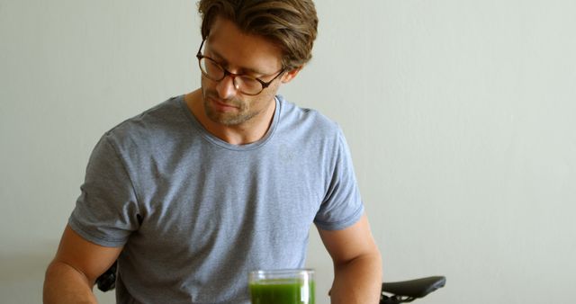 Caucasian man enjoys a healthy drink at home. He embodies a lifestyle focused on wellness and nutrition.