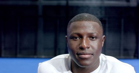 Athletic Male in White Sportswear on Blue Court