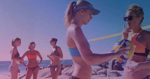 Women Sharing Strategies: Friends Preparing for an Exciting Beach Volleyball Game