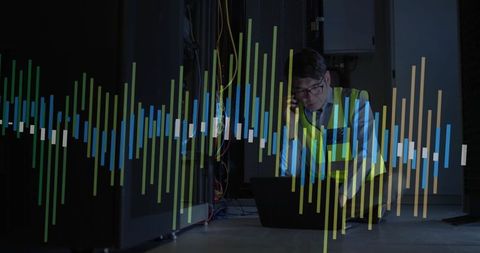 Technician Managing Datacenter with Smartphone and Laptop