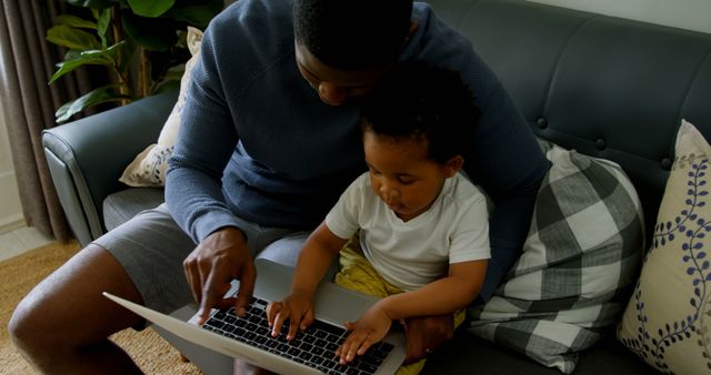 Father and Son Using Laptop on Couch - Download Free Stock Images Pikwizard.com