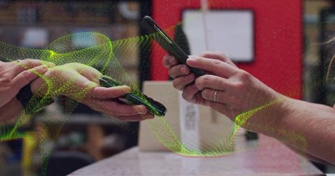 Hands tapping smartphones for contactless mobile payment and data transfer in retail