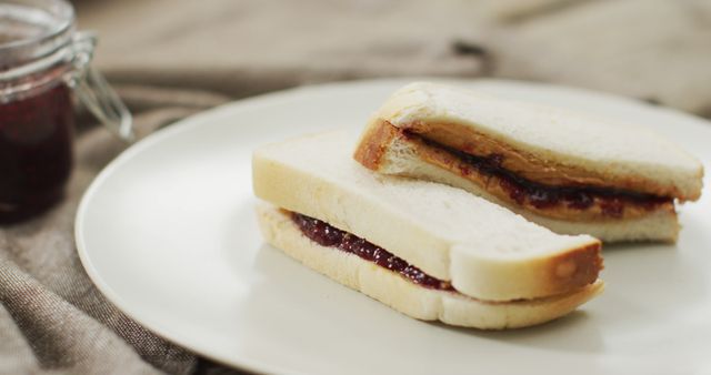 Close up of peanut butter and jelly sandwich in a plate - Download Free Stock Photos Pikwizard.com