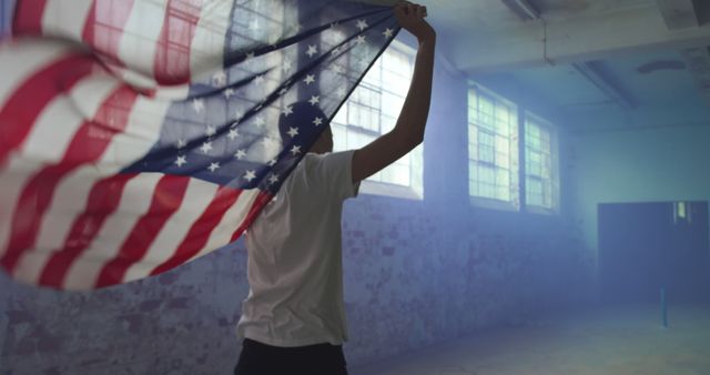 Young Person Holding American Flag in Abandoned Industrial Space - Download Free Stock Images Pikwizard.com