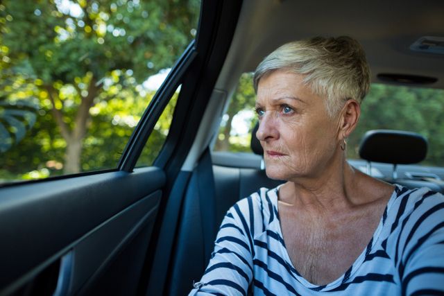 Senior woman looking through car window - Download Free Stock Photos Pikwizard.com