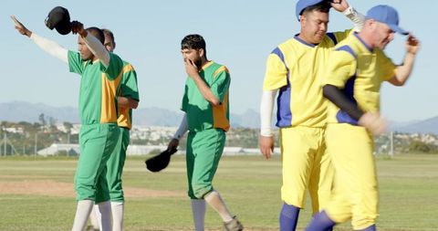 Cricket teams walking off pitch after match showing sportsmanship and teamwork