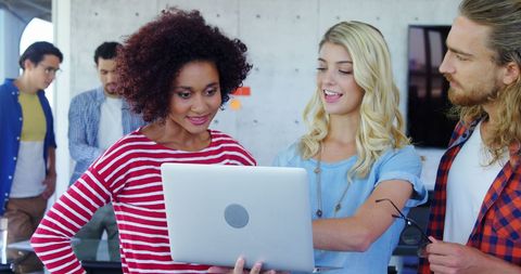 Diverse team collaborating in modern tech workspace