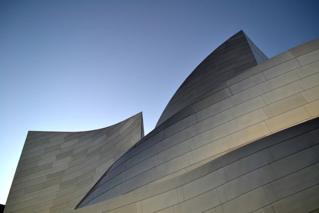 Modern Architectural Design with Curved Metallic Surfaces at Dusk - Download Free Stock Photos Pikwizard.com