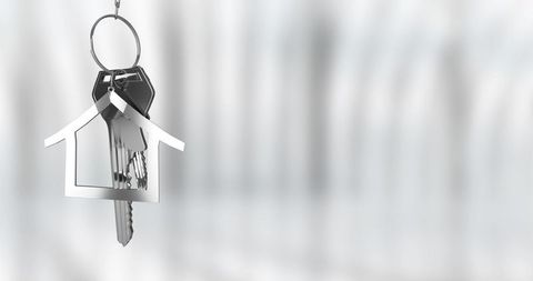 House-Shaped Keychain with Keys Hanging on Metallic Keyring