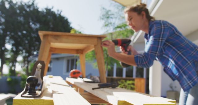 Woman Assembling Furniture Outdoors Using Power Drill - Download Free Stock Images Pikwizard.com