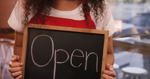 Cafe Owner Holding Open Signboard with Curly Hair - Download Free Stock Images Pikwizard.com