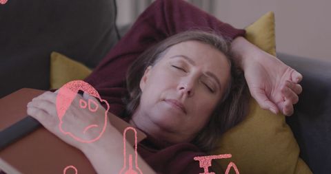 Woman Resting Peacefully with Book on Couch for Relaxing Afternoon