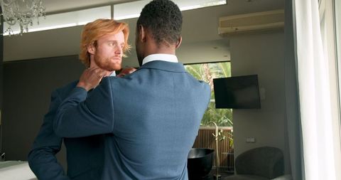 Groom engages in a heartfelt moment with best man before wedding