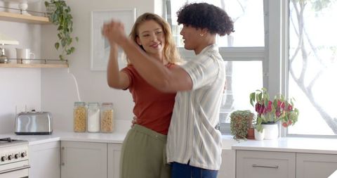 Couple Dancing in Bright Home Kitchen Creating Romantic Atmosphere