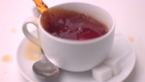 Close-up of Tea Splash with Sugar Cube in Motion