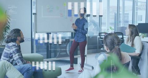 Leading team presentation with data overlays in modern bright office collaboration