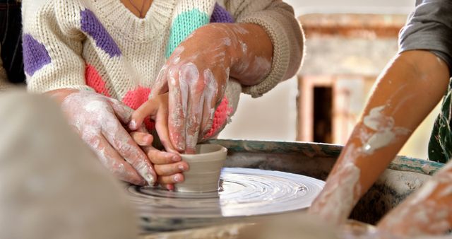 Child Learning Pottery with Instructor at Wheel - Download Free Stock Images Pikwizard.com