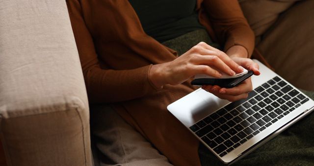 Woman Using Smartphone While Working on Laptop at Home - Download Free Stock Images Pikwizard.com