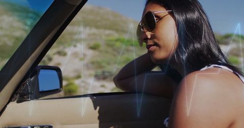 Relaxed road trip with woman in convertible car in scenic landscape