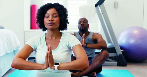 Couple Practicing Yoga Together for Health and Wellness