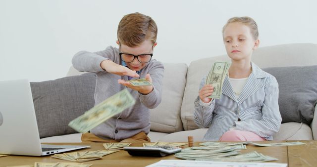 A young Caucasian boy and girl are engaged in managing finances or playing a money-related game, with copy space. He seems to be counting or distributing cash, while she holds money with a thoughtful expression, suggesting a learning activity or play about money management.
