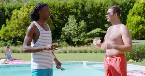 Diverse Friends Socializing By Swimming Pool on Sunny Day