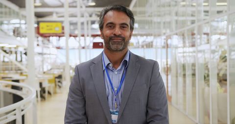Confident Businessman Standing in Modern Office Environment