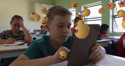 Students Engaging with Technology Amused by Positive Emojis in Classroom